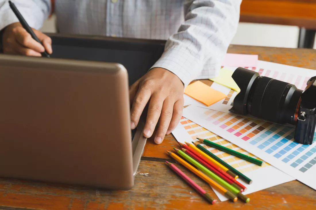 midsection-man-using-laptop-table